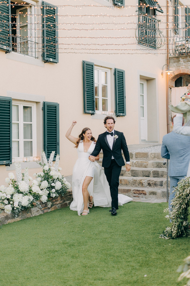 bride and groom celebrating as they enter their wedding dinner area