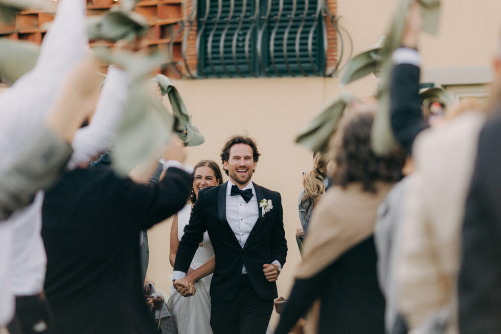 bride and groom celebrating as they enter their wedding dinner area