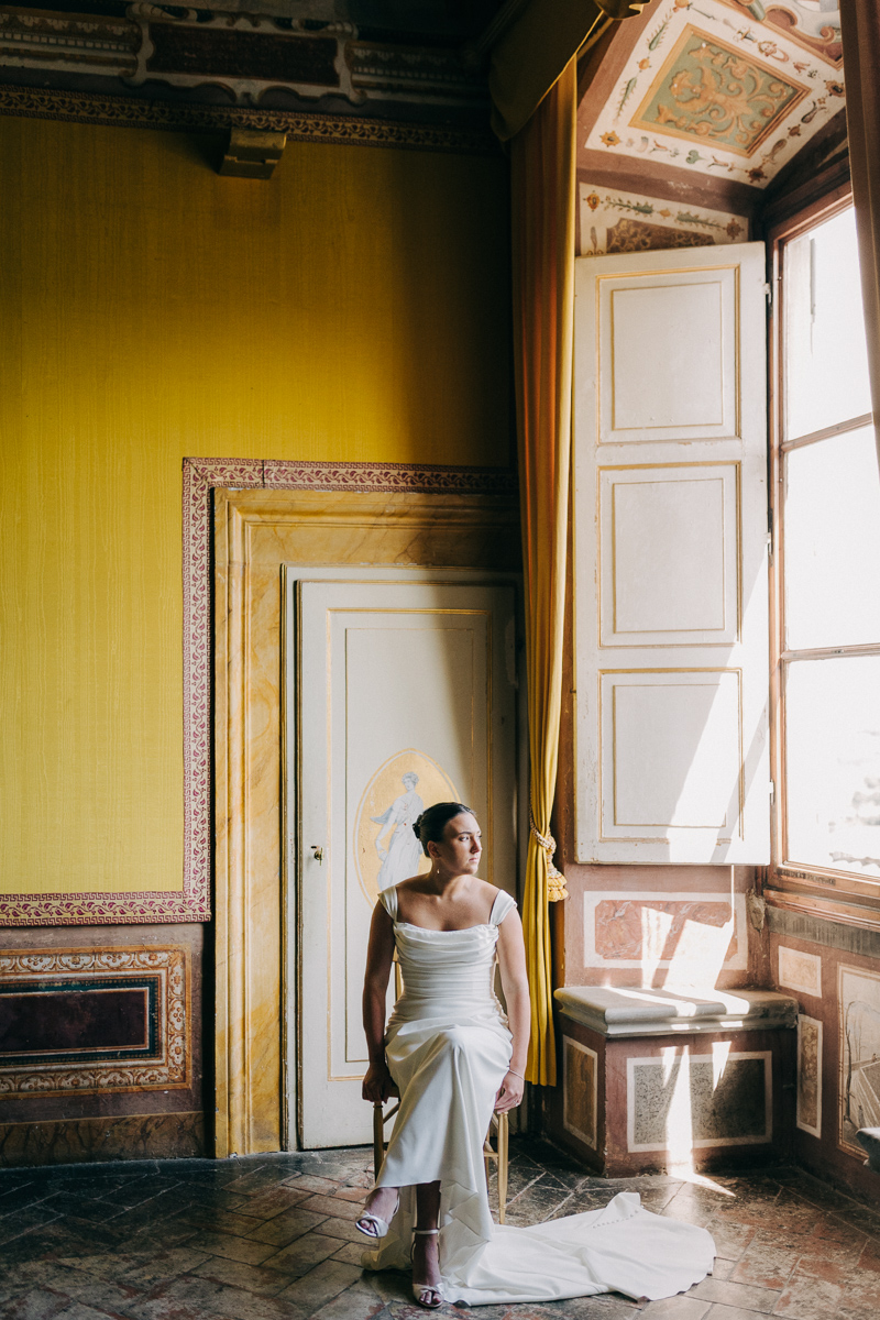 Bride seated in the frescoed yellow salon